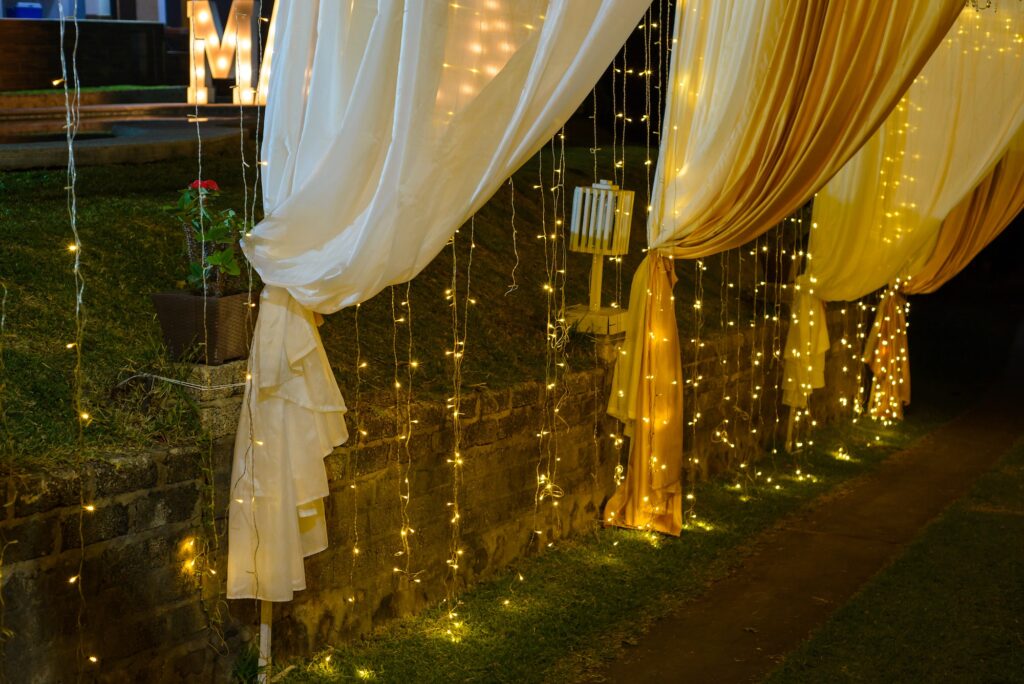 Hallway decorated with curtains and Christmas lights.